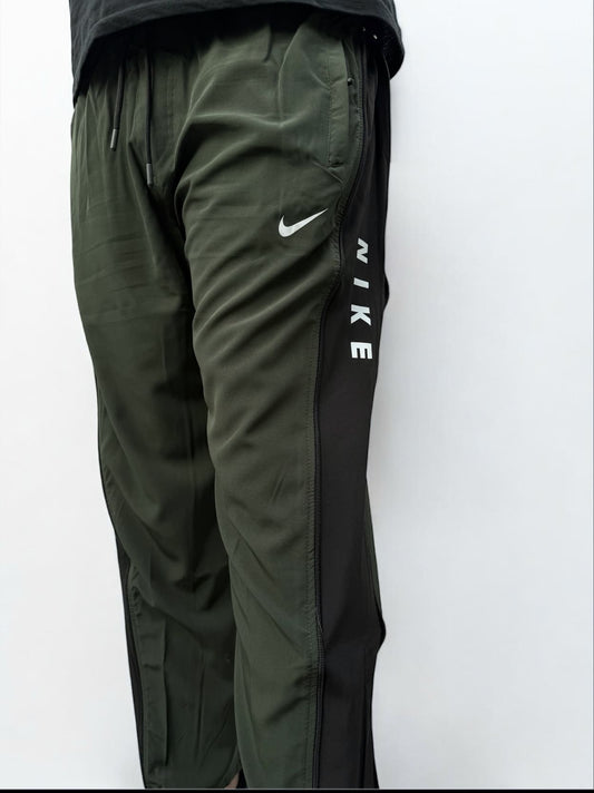 Green Nike pants on a white background